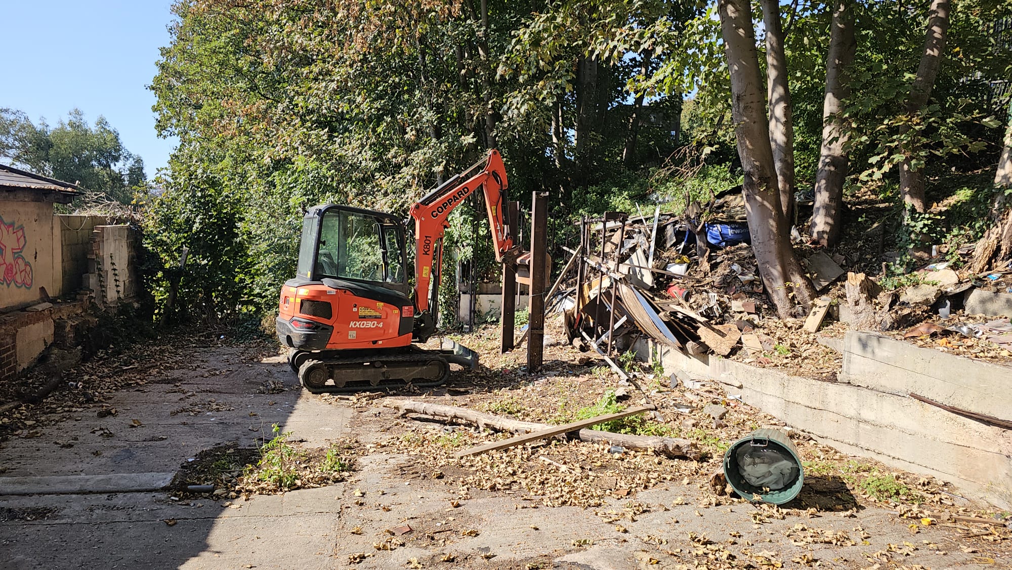 Mini excavator digging out a cleared site, the kind of groundworks where excavated soil needs WAC testing before it can go to landfill.